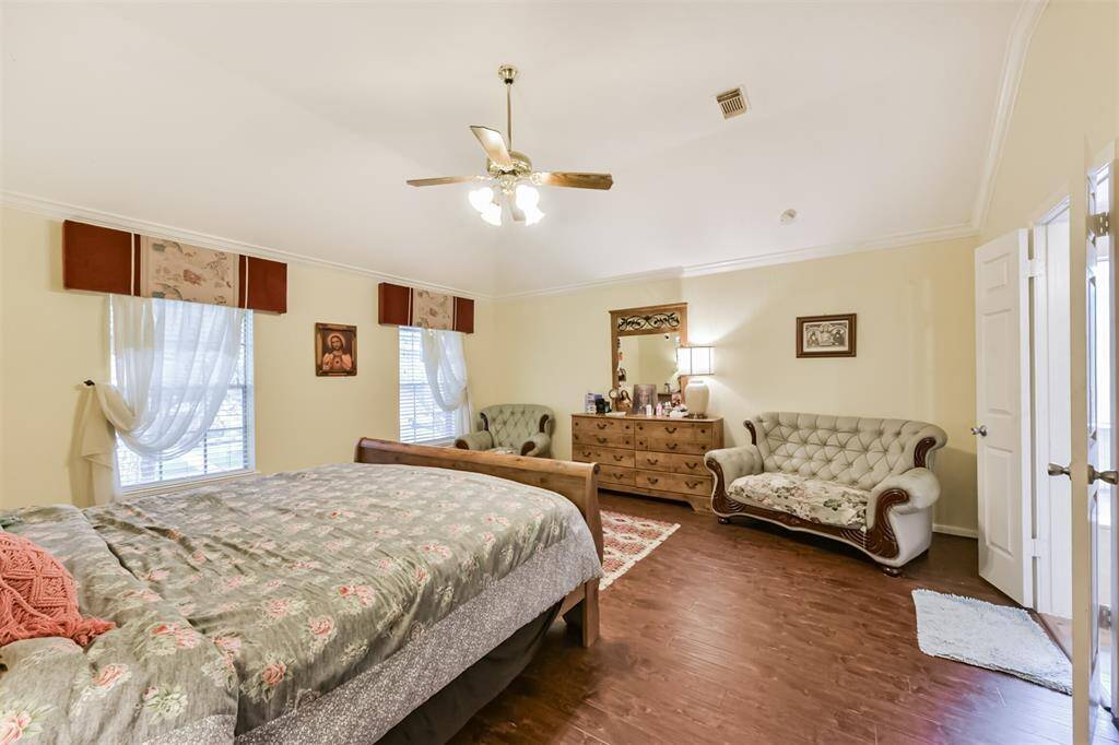 Spacious primary bedroom with engineered wood