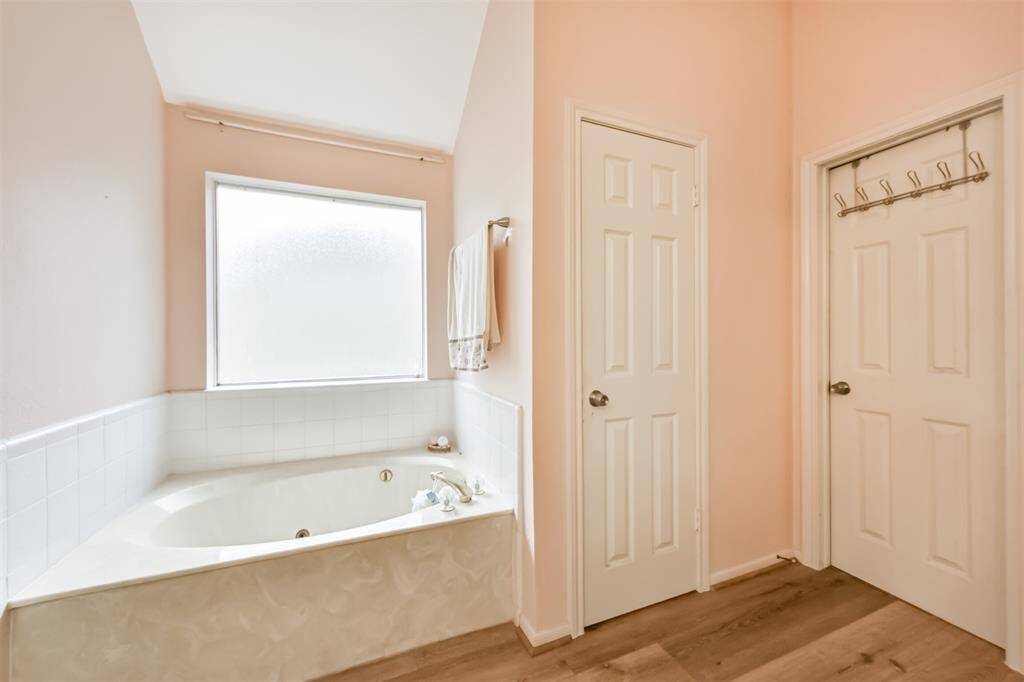 primary bathroom with stand alone shower and tub