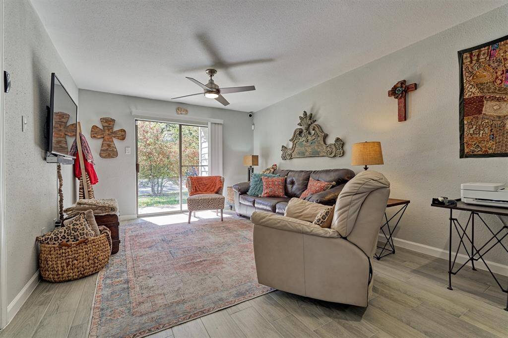 Spacious living room with abundant lighting and outdoor access.