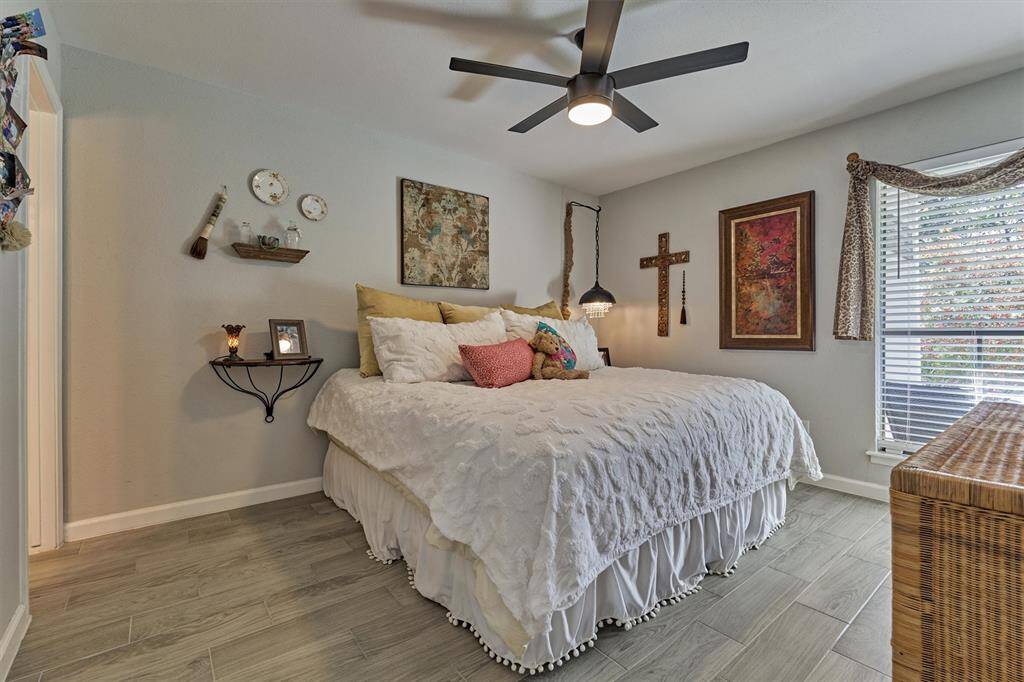 Discover your tranquil haven in this chic and serene primary bedroom, designed for relaxation and comfort.