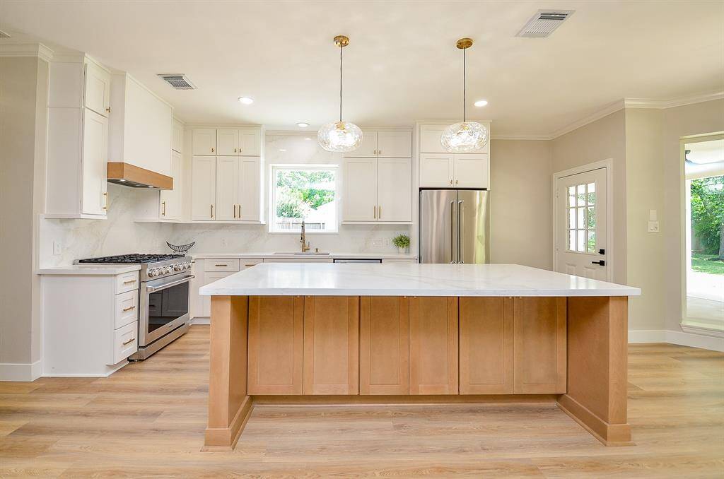 Culinary excellence with top-tier appliances and a stunning backsplash in this dream kitchen.