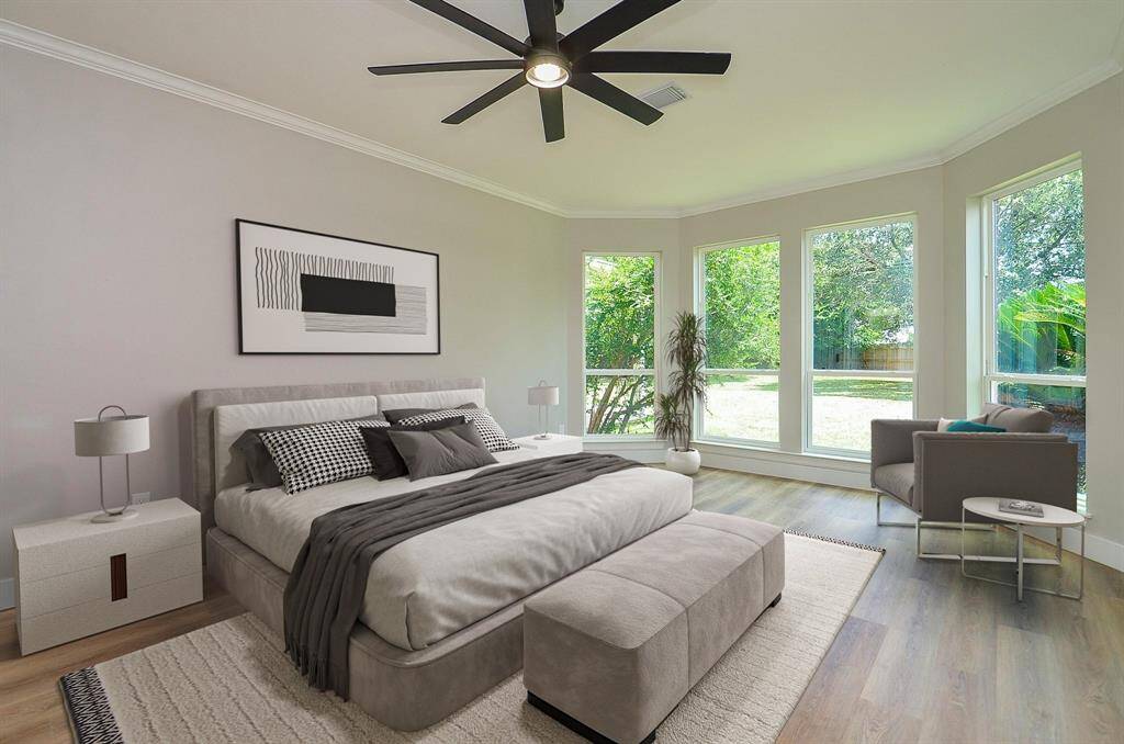 Spacious and inviting primary with a wall of windows to enjoy the beautiful scenery of the vast yard
