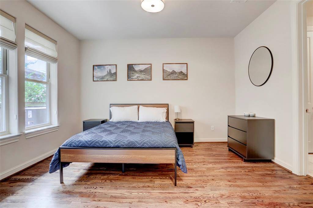Spacious downstairs bedroom with ensuite bathroom. Light and bright with real wood floors. Walk-in closet for lots of storage space. Great view of backyard space! Double-paned windows throughout.
