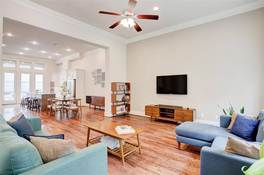 Another view of spacious living area looking toward the dining room and kitchen. This home also has many energy efficient features such as the radiant roof barrier in attic and a tankless hot water heater!