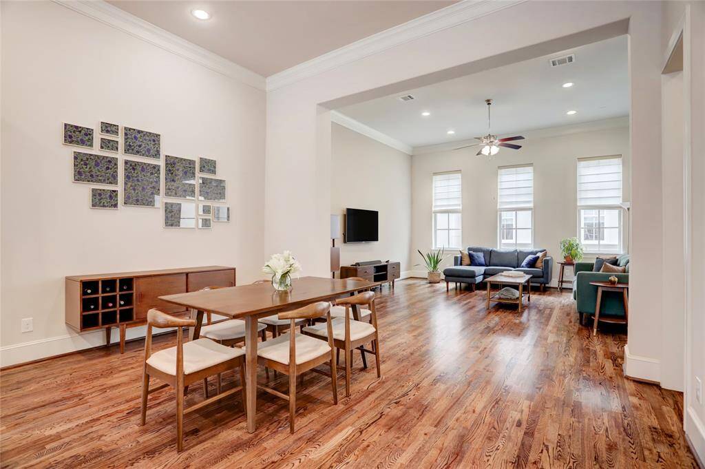 View of large dining area looking toward the living room. Plenty of room for even the largest sectional sofa and imagine celebrating the holidays with a big meal. Plenty of room to expand the size of your dining room table to accomodate lots of guests. Crown molding on 2nd floor.