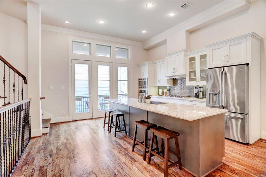 Notice the glass door off kitchen which lead to another outdoor balcony.  The high transom windows  really highlight the great height in this space!