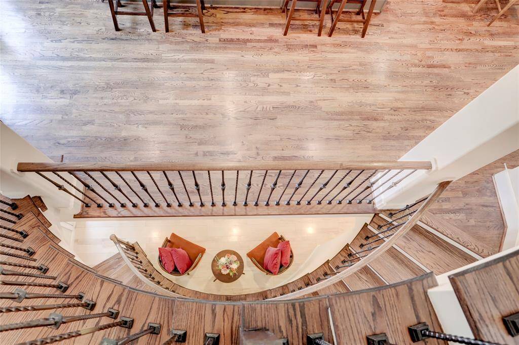 View from the top of the staircase on the 3rd floor looking down on the 2 floors below. Notice the beautiful rich, real wood floors, even on the stairs!