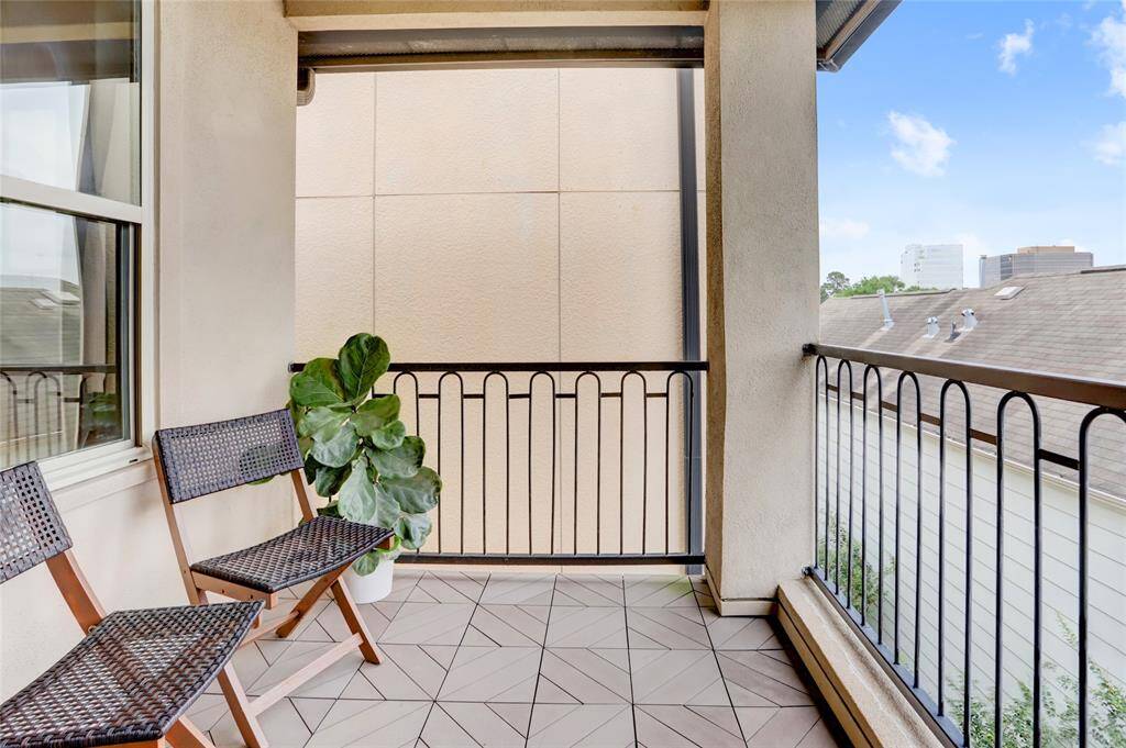 3rd floor balcony with wrought iron railing give you a bird's eye view of the neighborhood!
