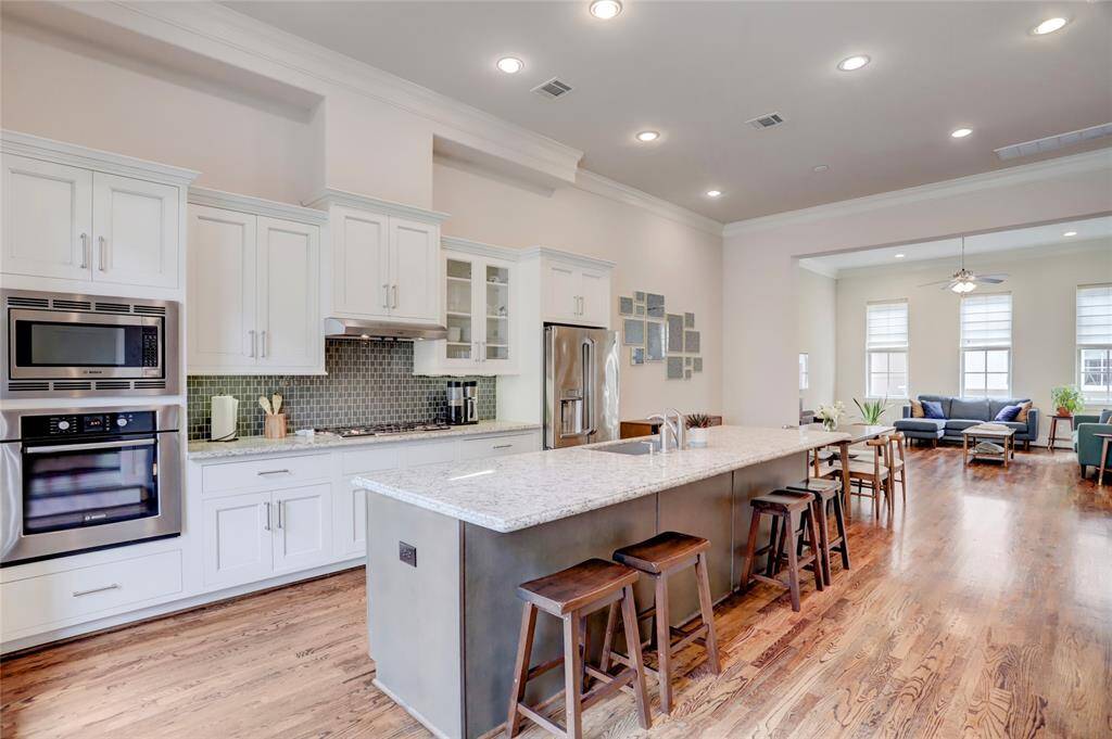Amazing kitchen with Bosch Stainless steel appliance package! Huge island with stainless steel sink. Room for lots of additional seating at the island or use it as a serving bar to set up a buffet meal. Shaker style cabinets, some with glass fronts. Undercabinet lights!