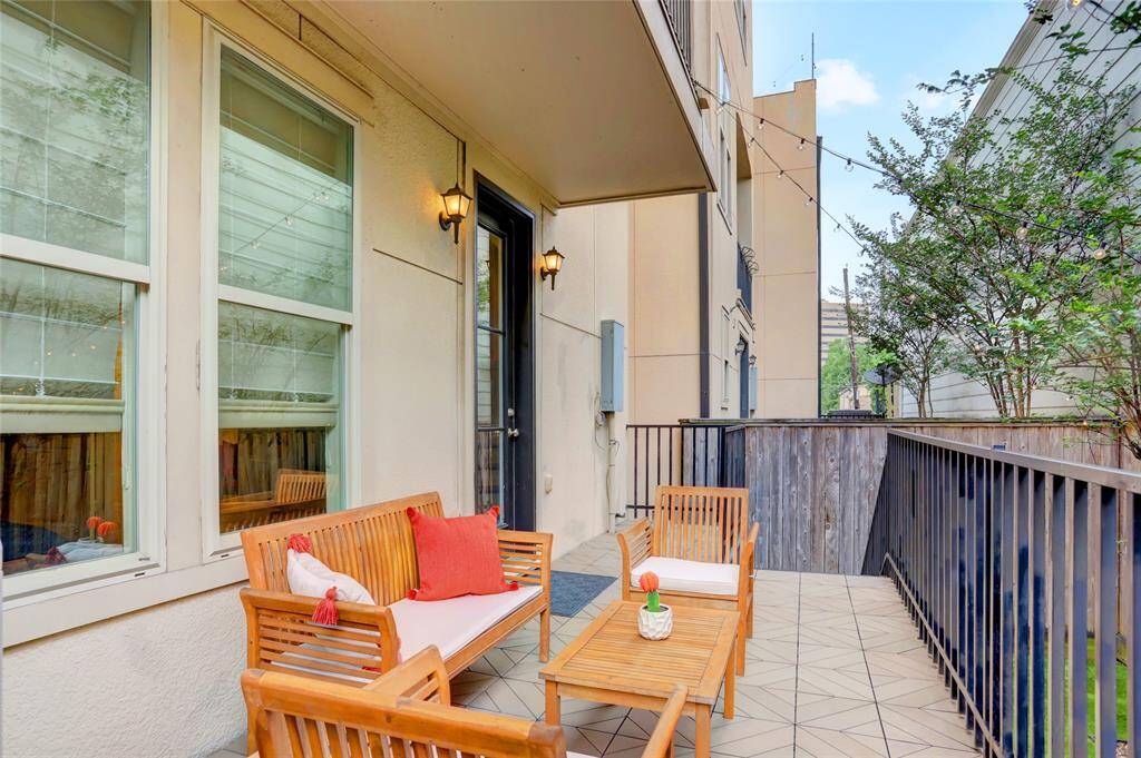 Fabulous back deck with wrought iron railings Perfect spot for relaxing or entertaining! Gas hookup for outdoor cooking! Notice wood privacy fence. String of white lights makes it a festive atmosphere in the evenings!