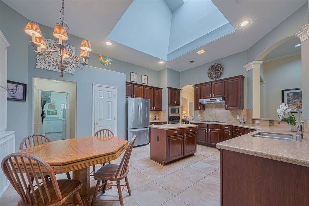 French doors off the entry lead to the home office/study which includes a large storage closet complete with built-in shelving. The back wall winds around to a full bath, utility room, garage and kitchen.