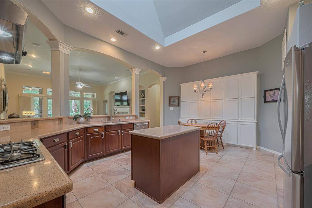 A built-in cabinet behind the breakfast area offers generous storage space, keeping the kitchen organized and clutter-free.