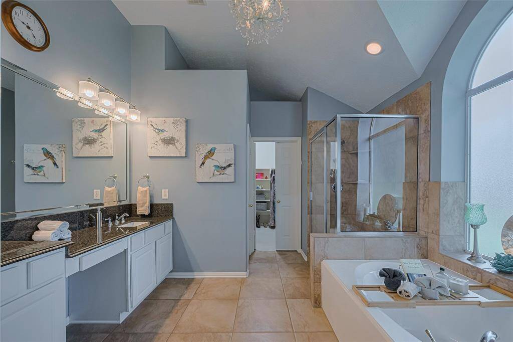 The spa-like primary bathroom combines architectural beauty with the comfort of a private retreat, perfect for unwinding at the end of the day.