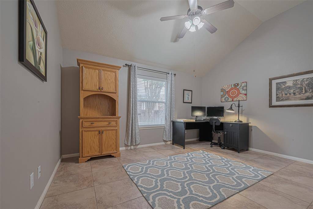 The third bedroom on the first-floor is also primary-sized and includes solid-surface flooring and a tall ceiling that adds to its open, airy feel.
