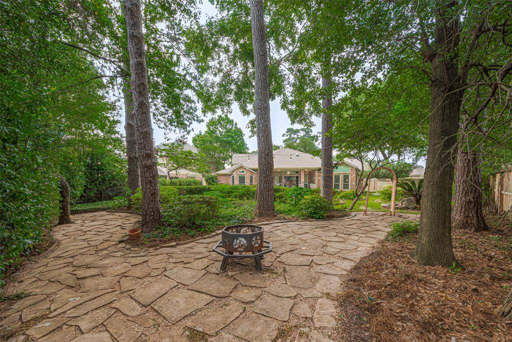What a view! Paved pathways for strolling through the masterfully landscaped backyard.