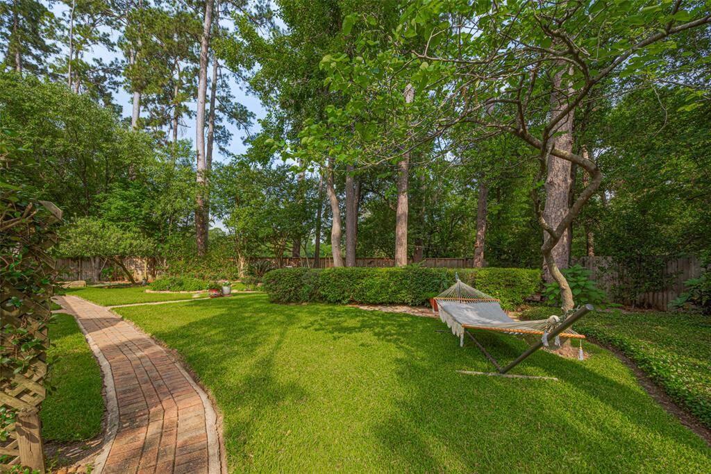 You'll forget you're so close to the city when you step into this woodland landscape. Mature azaleas, rose gardens, lemon tree, mulberry tree and so much more provide new surprises every season. Watch birds play in the soothing fountain. You may never want to leave home.
