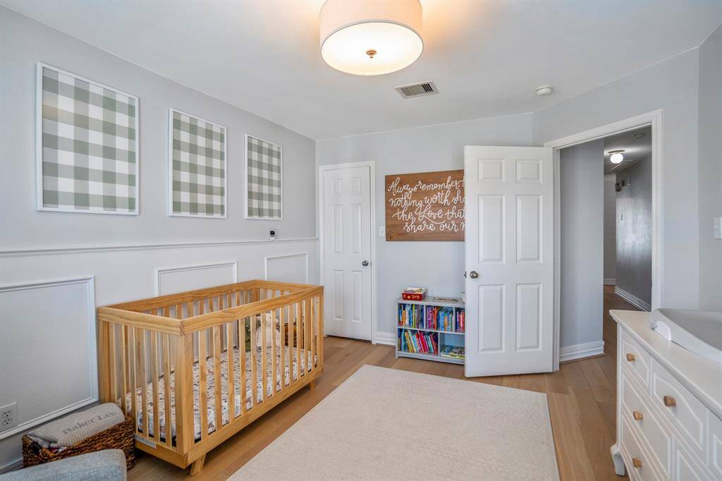Another view of the nursery/secondary bedroom showcases the room’s versatility, whether you’re setting up for baby, play, or a future guest space.