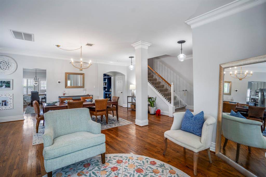 With hardwood floors, tall ceilings, and sight-lines that carry through the home, this living space effortlessly balances comfort and sophistication, inviting you to settle in without sacrificing style.