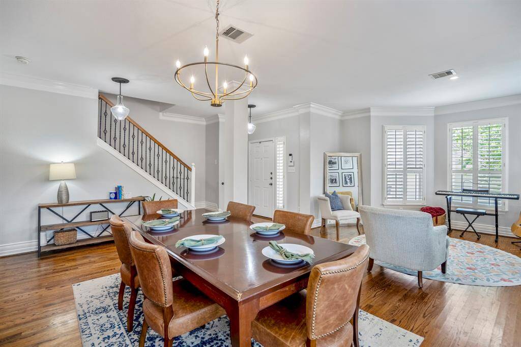 Anchored by elegant lighting and surrounded by natural light, the formal dining room is equally suited for intimate dinners or stylish hosting, with enough space to entertain everyone on your A-list!
