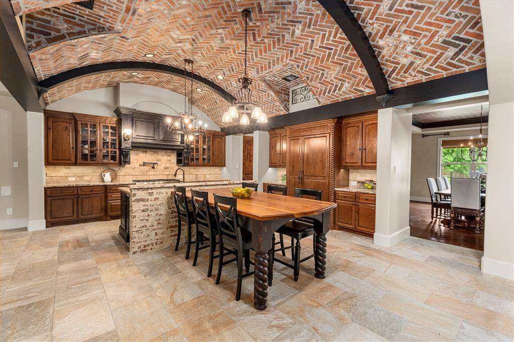 Thermador Stainless steel appliances including a 6 burner gas range plus griddle, built-in sub-zero refrigerator and double ovens , warming drawer, pot filler, and oversized walk-in pantry.