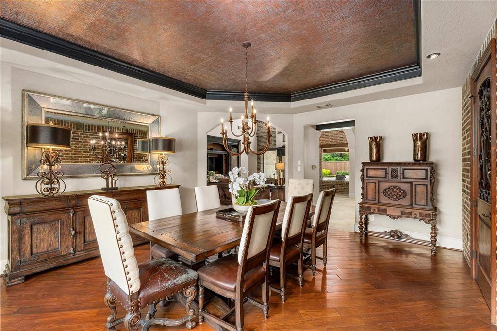 Formal dining with double knotty alder doors with iron accents open into the spacious wine grotto which offers ample storage for your finest beverages.
