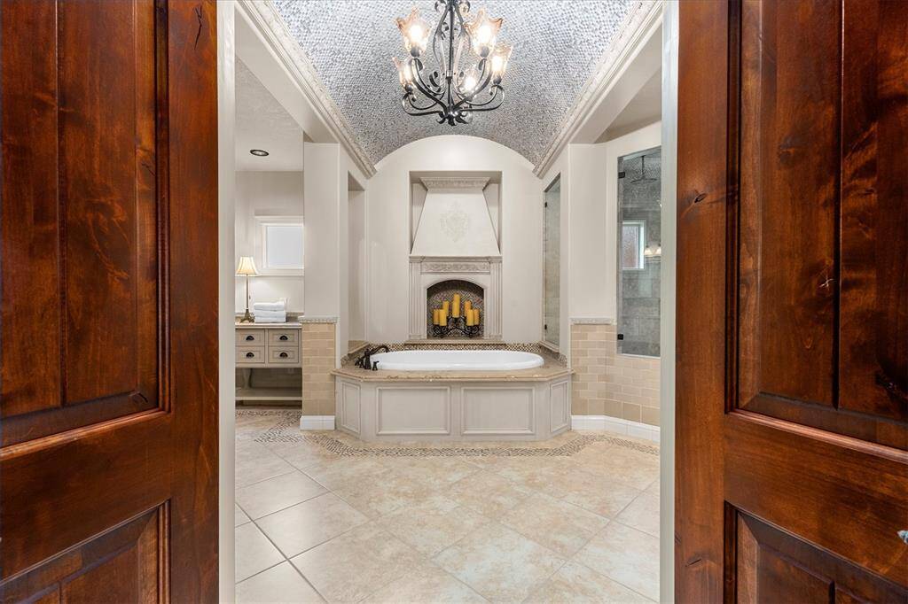 Spa-like primary bath will truly take your breath away!  From the gorgeous tiled barrel ceiling to the air jet tub and oversized walk-in shower with built-in towel warmer.