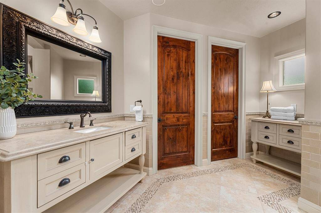 Custom built vanities, built-in television (hidden behind the vanity mirror) Plus so man additional custom features including a well thought out walk-in closet that has private access straight into the laundry room!