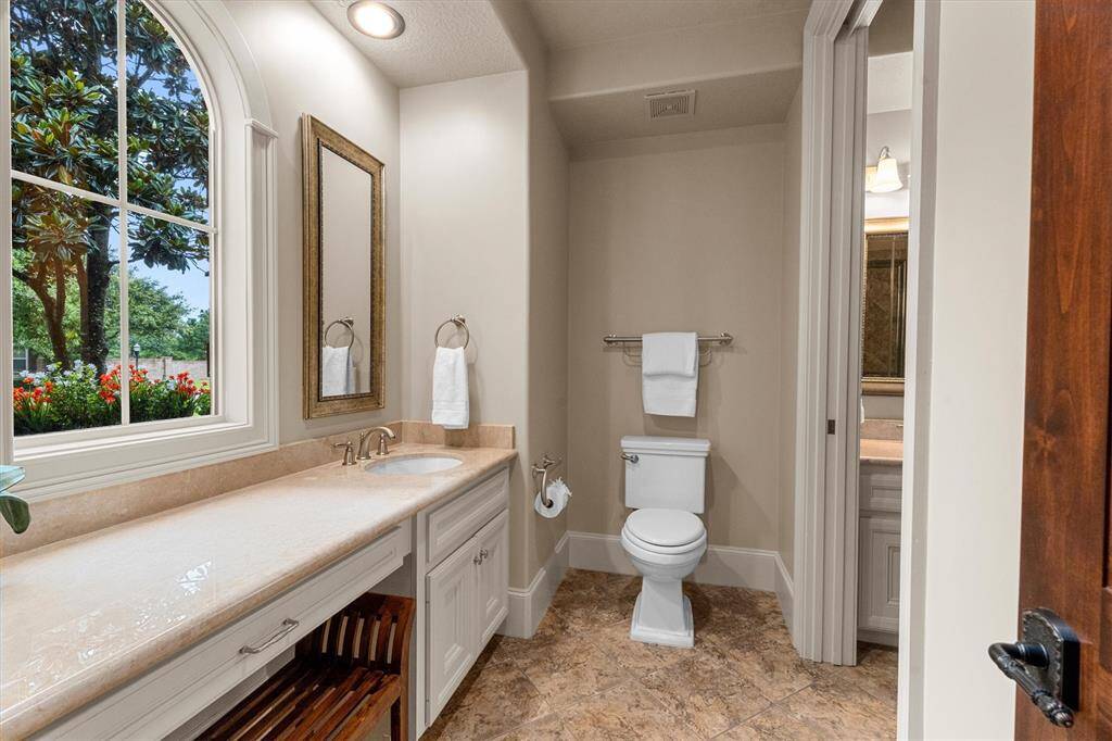 2nd Bedroom En-suite bathroom with vanity and wheelchair accessible shower