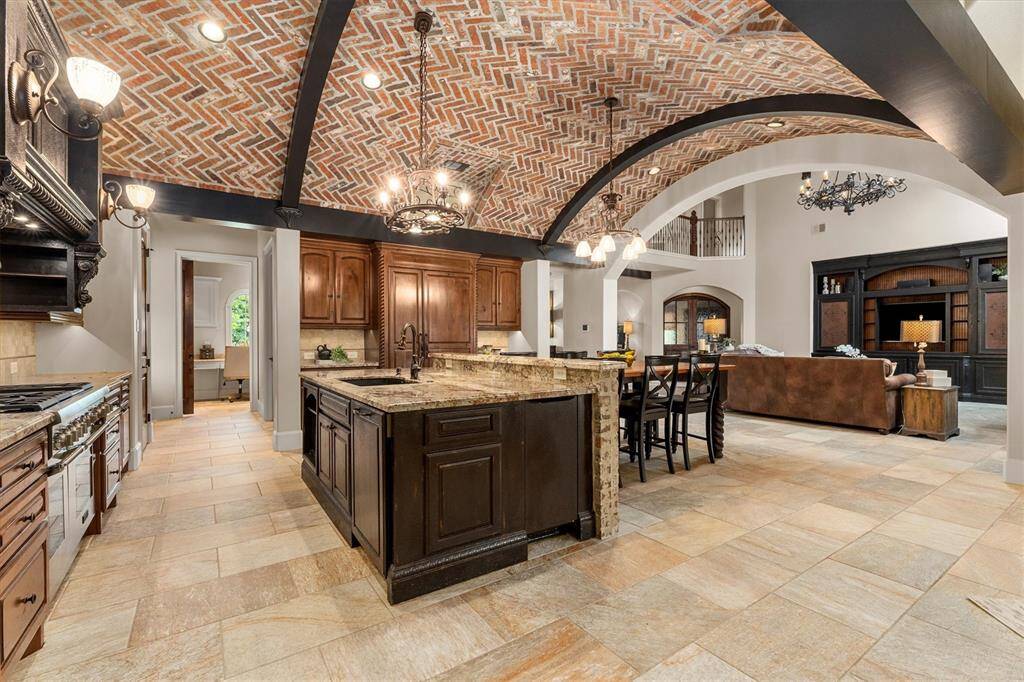 Herringbone barrel ceiling with wood beams sets the stage on this one of a kind gourmet kitchen