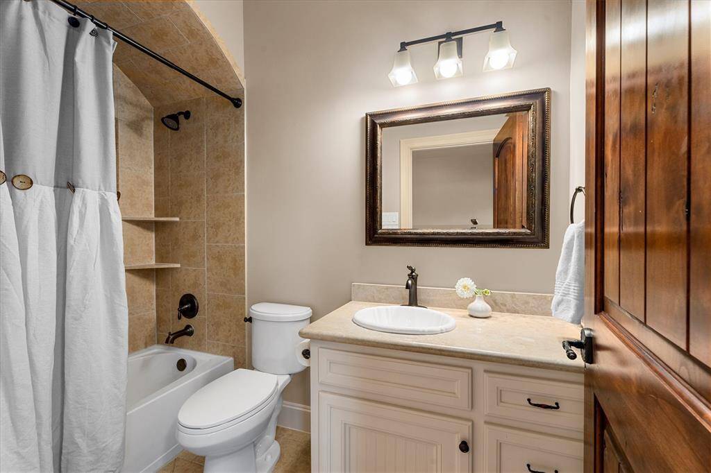 En-suite for bedroom #3 with stone counters and upgraded tub/shower