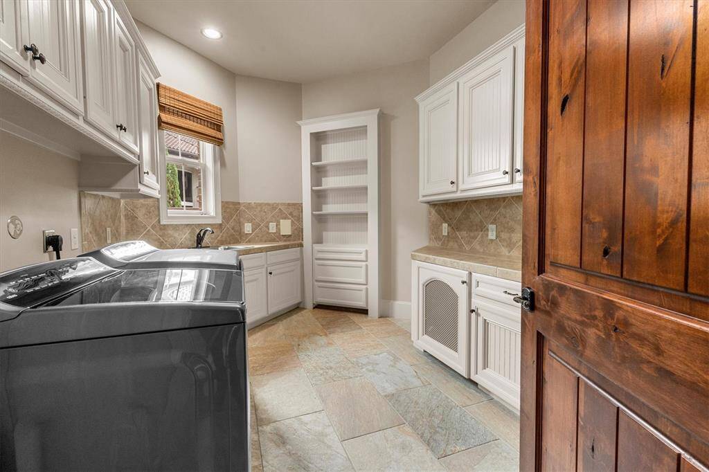 This utility room is to die for with access to the primary closet.