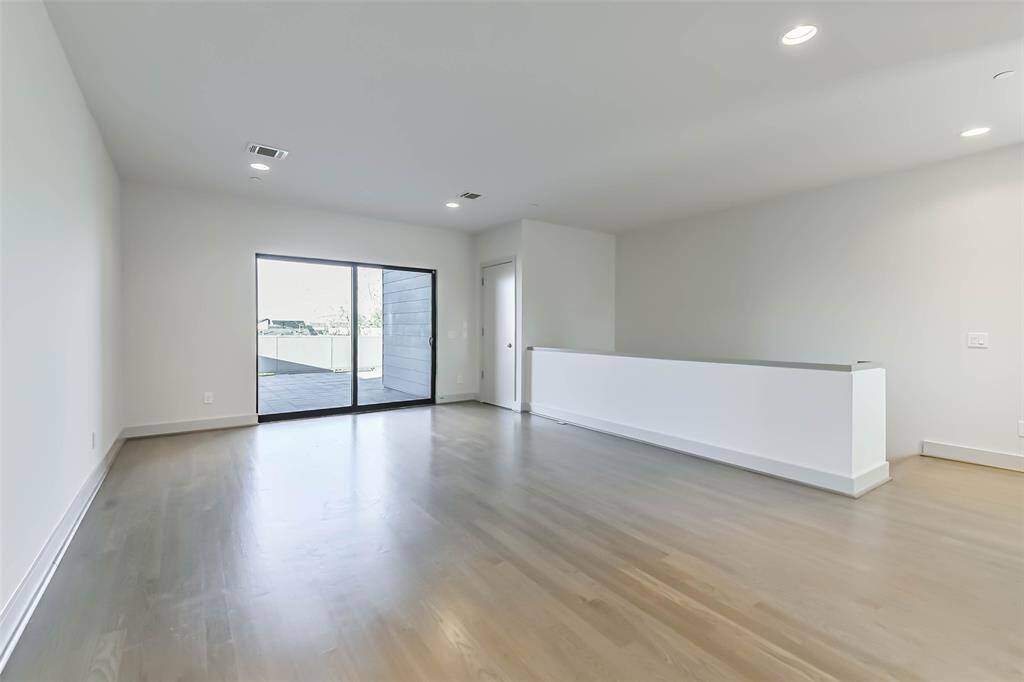 The spacious game room offers a versatile space for relaxing or entertaining.  Access one of two roof top terraces through the glass sliding doors and appreciate views of Downtown Houston. A full bath and closet make this space a possible 4th bedroom.