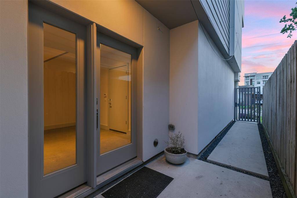 Charming and clean lined walkway welcomes you to the double glass front door.  The wrought iron gate provides privacy.