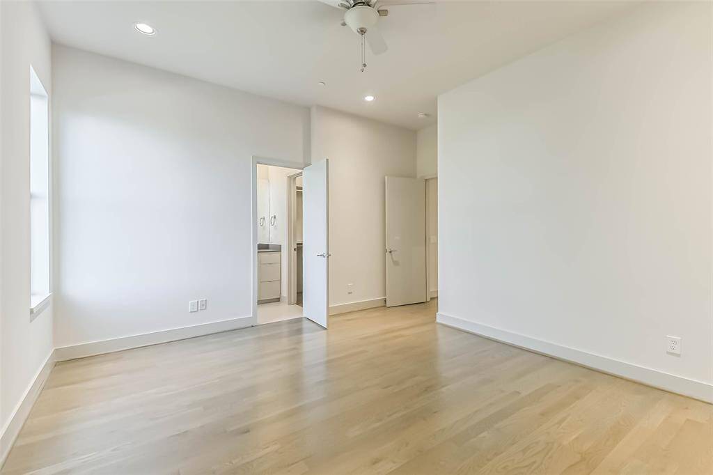 Secondary bedroom located opposite the primary suite, features recessed lighting, ceiling fan, hardwood floors and large window.  Access to full bathroom and walk in closet make this an excellent guest suite or child's room.