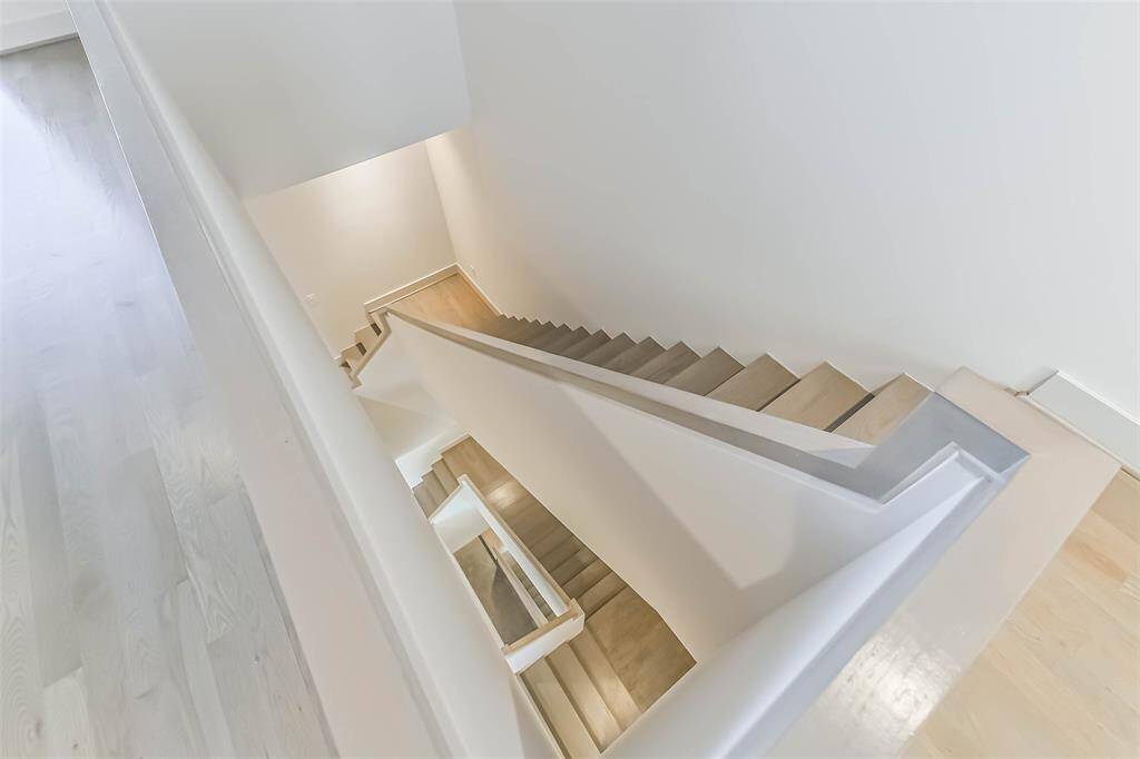 The dramatic staircase is just one of the unique features of the architectural design.