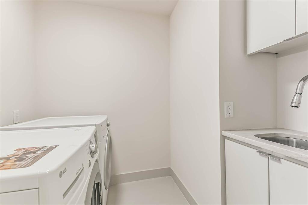 The laundry room has a sink and is conveniently located next to the primary and secondary bedrooms.  LG washer and dryer are included with the home.  Ample space and storage.