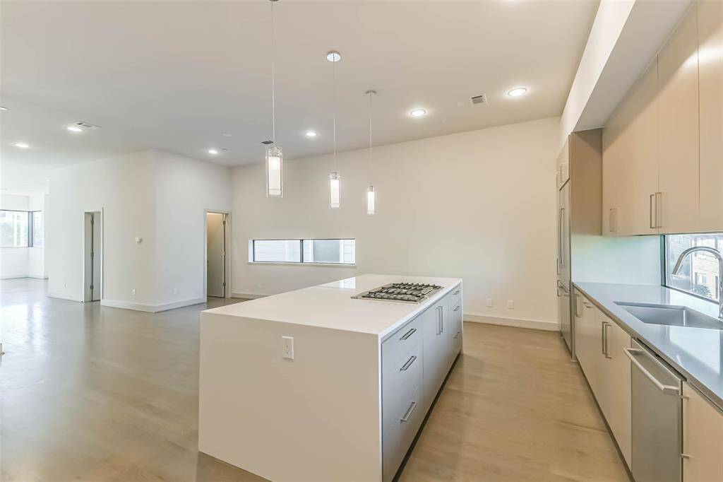 Kitchen view showcasing the siltstone waterfall island and cabinetry.