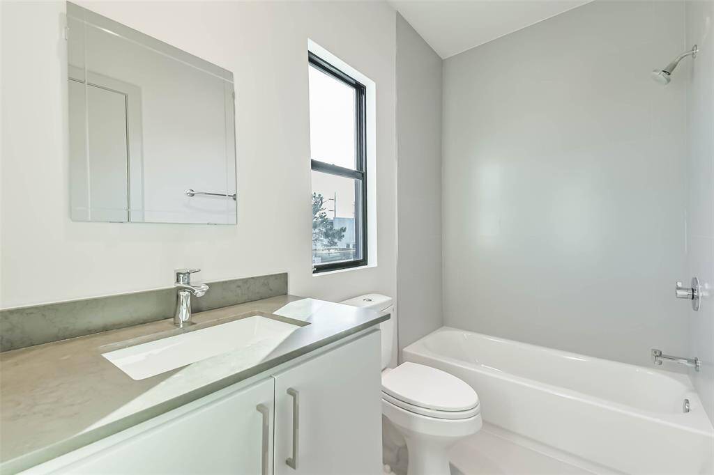 Secondary bathroom located off the game room.  Classic finishes and natural lighting.