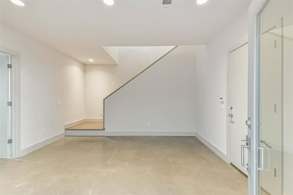Spacious entry boasts polished concrete flooring, access to the garage, storage closet and access to a bedroom/office with a full bathroom. The natural light emanates from the bedroom which overlooks the back yard, the entry way with glass doors and the second floor windows.