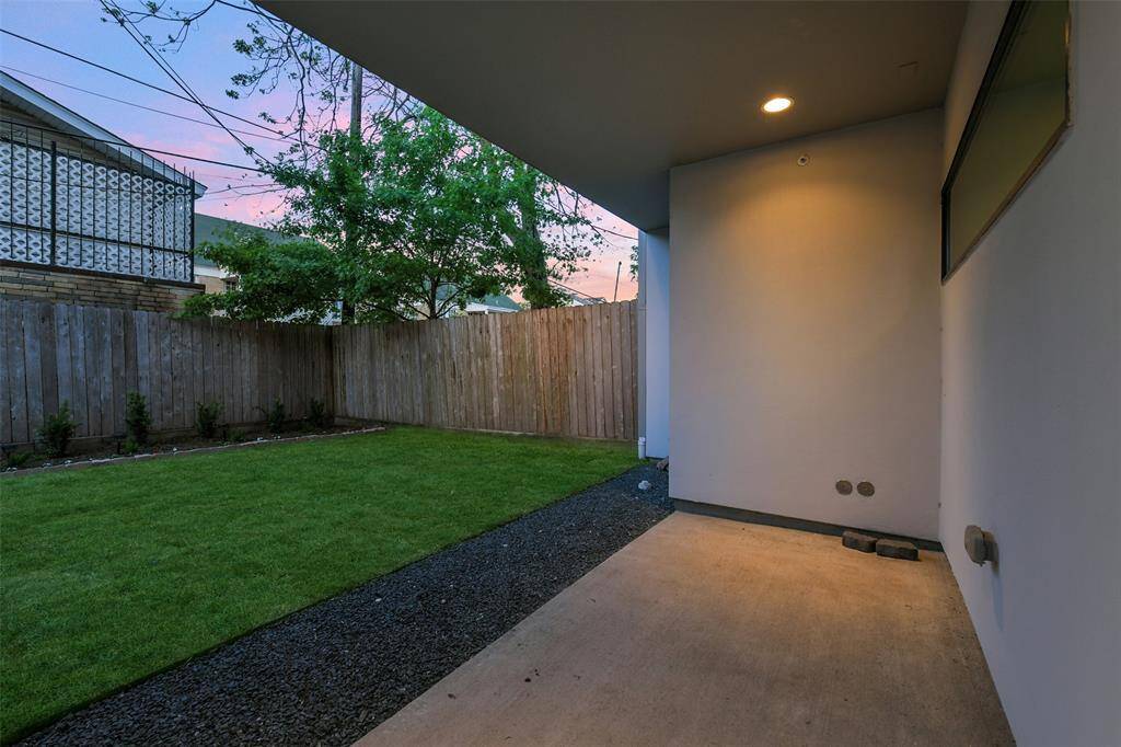 The covered patio downstairs has ample space for seating, an additional area for a grill or summer kitchen and over looks the landscaped back yard.