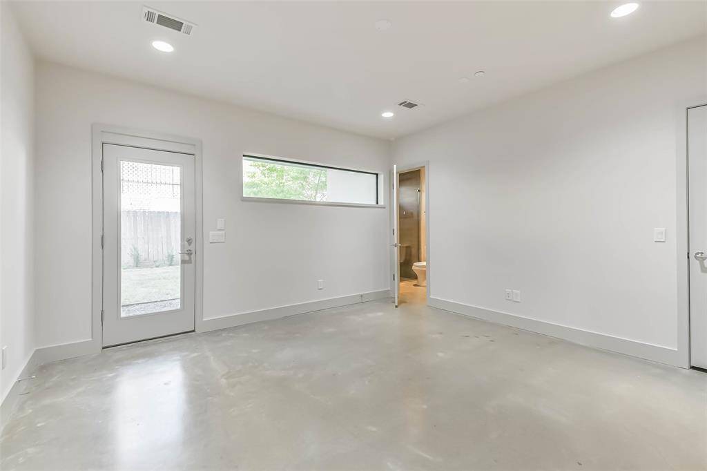The first floor Bedroom with ensuite bathroom, closet and access to the backyard could double as an office or additional living space.
