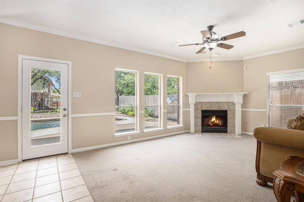 This is the Informal living area/den right off the kitchen. Notice the corner fireplace, ceiling fan, and view!