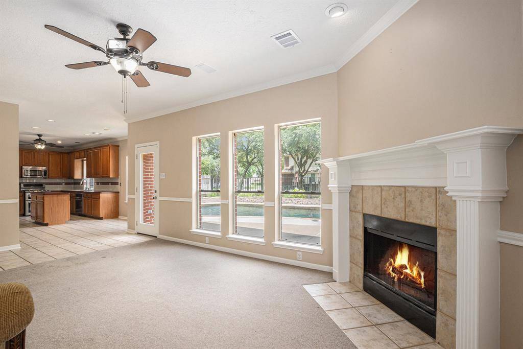 Standing in the corner of the informal living area, looking towards backyard and ktichen.