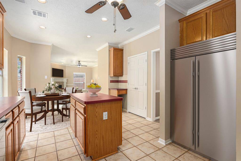 This angle shows the openness of the kitchen to the informal living area. Virtually staged