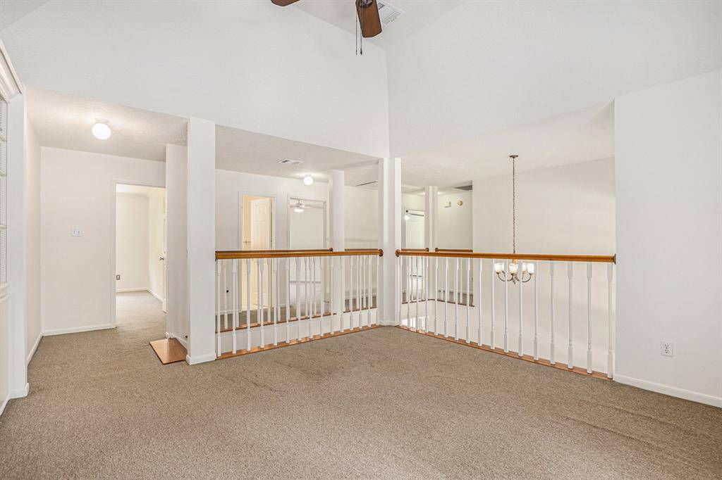 Huge upstairs flex space with a VERY large walk in closet and built in shelves. High ceiling and storage for days!