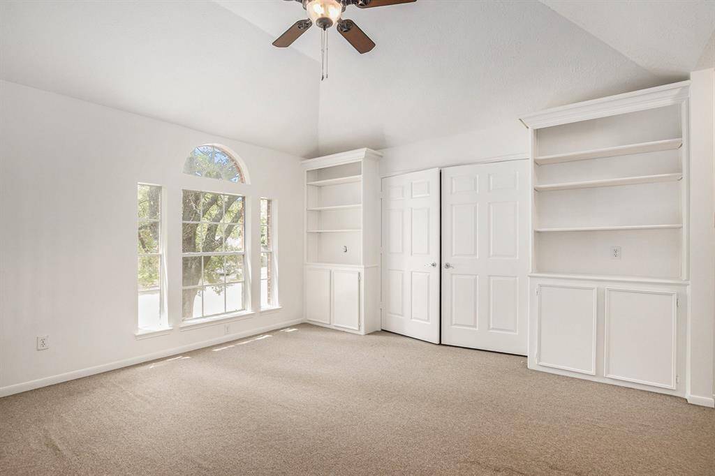 Huge upstairs flex space with a VERY large walk in closet and built in shelves. High ceiling and storage for days!