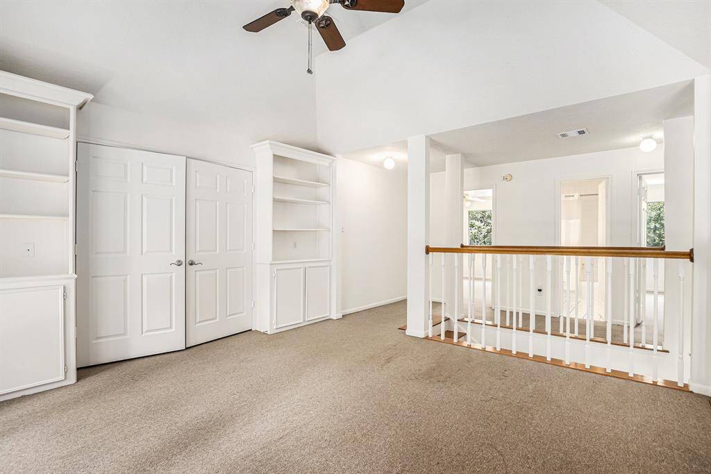 Huge upstairs flex space with a VERY large walk in closet and built in shelves. High ceiling and storage for days!