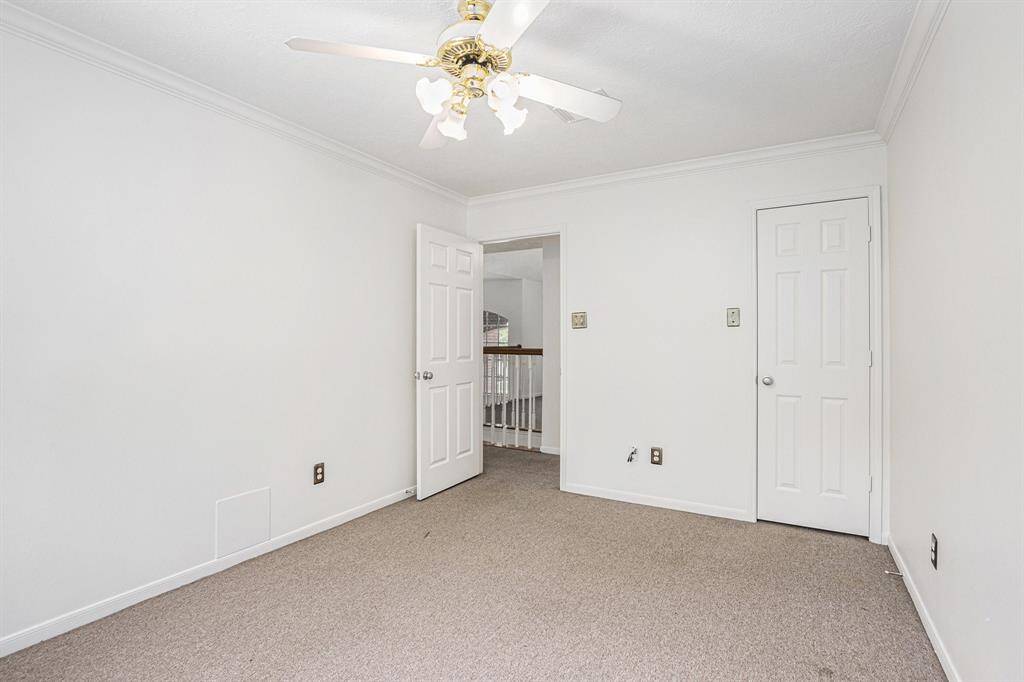 Upstairs secondary bedroom, high ceilings, and ceiling fan