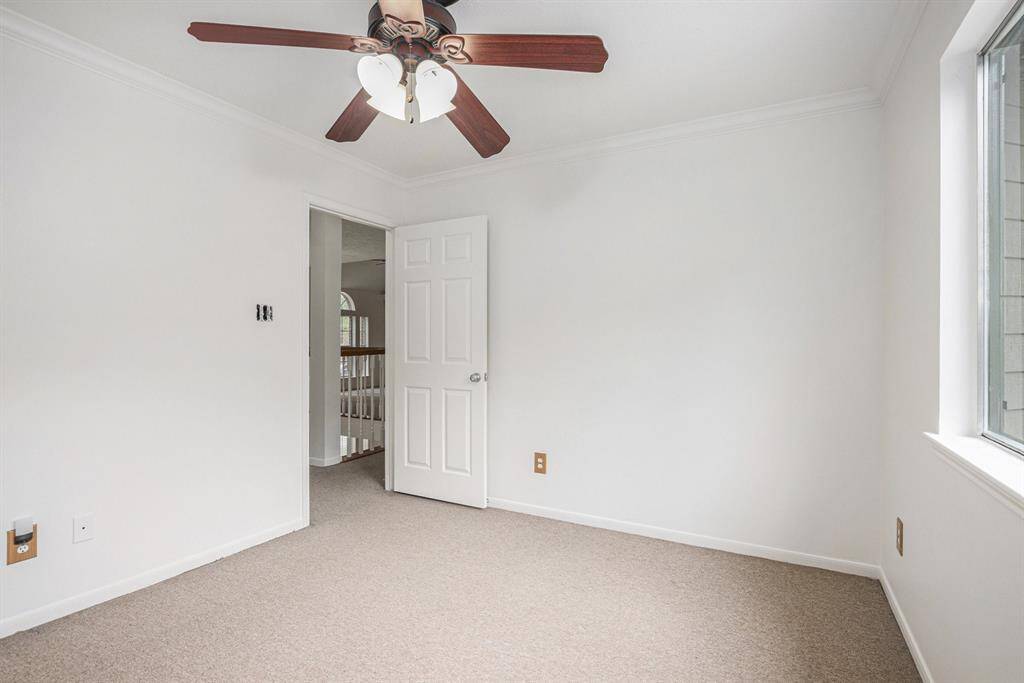 Upstairs secondary bedroom, high ceilings, and ceiling fan