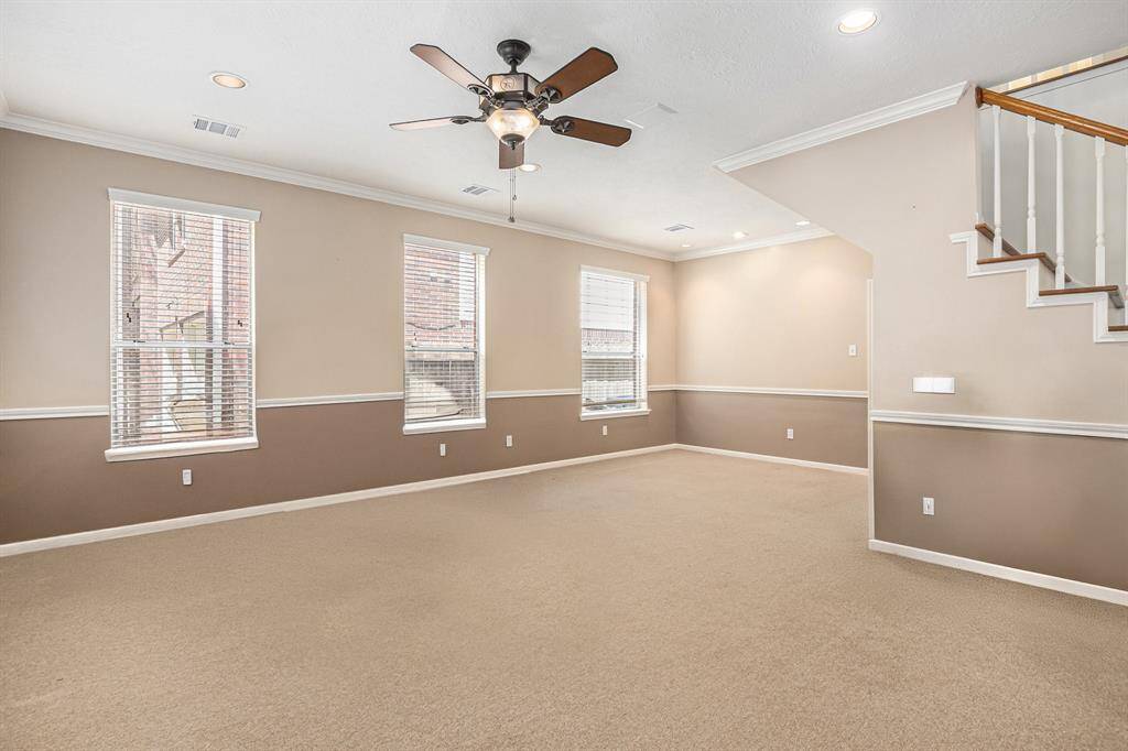 Formal living room, complete with ceiling fan. Waiting for you to bring your custom touches!